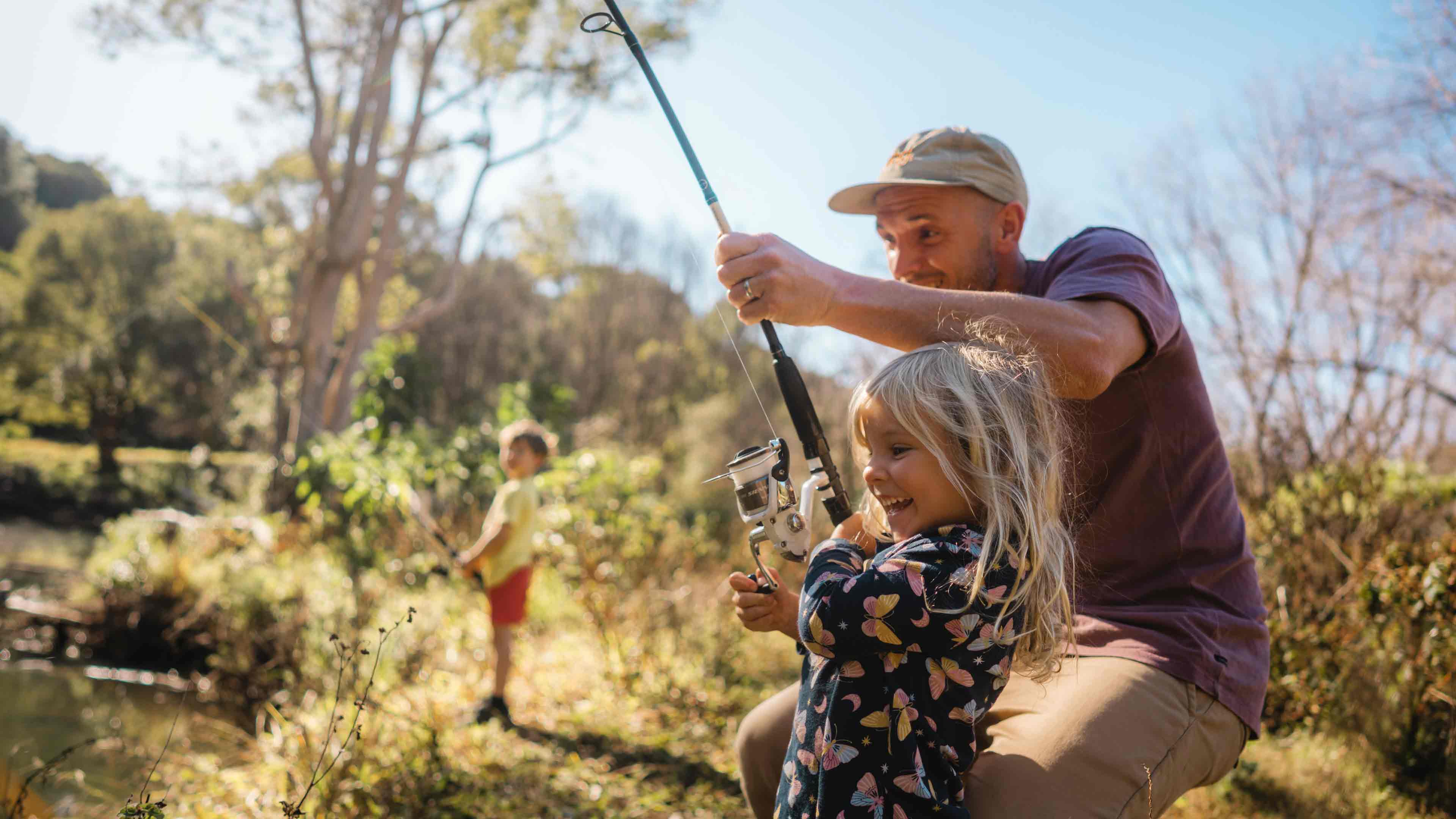 Man fishing with children in Australian river